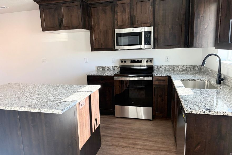 This beautiful new townhome was built with care and attention to detail. This home offers affordable comfort with quality. You'll love the granite countertops, LVP flooring, and bright, timeless design that make it feel like home the moment you walk in. This home has 2 bedrooms with a bathroom on the main floor and one upstairs by the bedrooms. It is at a great location close to amenities in Tremonton.