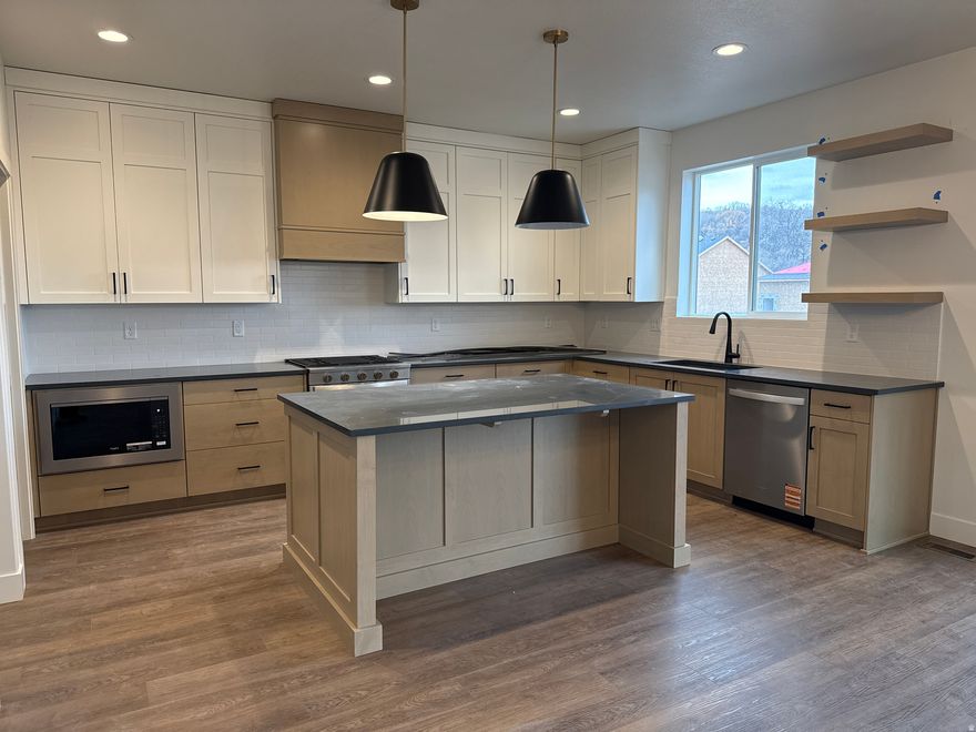 WOW!! LIMITED TIME rate promotion available on select homes!! 4.99% on 30-yr fixed FHA/VA or 7/1 ARM with preferred lender. Conditions and terms apply. Offer expires 3/31/2026. Ask agent for details. Just finished, beautifully designed two-story Craftsman home with four large bedrooms, two family rooms, versatile office/sitting room, oversized 4 car garage on a large lot. Spacious kitchen with beautiful hood, quartz countertops and large pantry. Storage galore throughout this home and room to grow in the basement. Centrally located with easy access to I-15, I-84 and US-89. Indoor soccer park, pickleball courts and parks nearby. You'll LOVE our Riverwood community in South Weber, come see what all the talk is about!