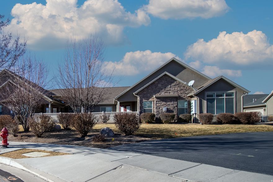 Vibrant 55+ community with a clubhouse, exercise room, swimming pool, theater room, and library.  Beautiful grassy areas with walking paths.  East facing patio has spectacular mountain views.  Upgrades include a tankless water heater, master bath with a roll in shower and a walk in tub, 2nd bathroom has a walk in shower,  Features stunning quartz countertops and newer appliances in the kitchen, and fresh 3 tone paint throughout, a large office space plus three spacious bedrooms.  Large double garage is wide and extra deep for additional storage you may need.  Don't miss this one!