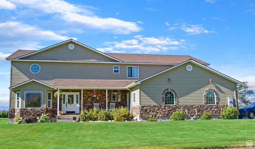 Nestled in the heart of Marsh Valley, this 6 bedroom, 2.5 bathroom home with acreage is a must see.  You will experience beauty the minute you walk in the door as you are greeted by the spacious living room with a cozy fireplace and custom wood staircase.  As you make your way into the kitchen you'll find custom knotty maple cabinets, granite countertops, a double oven and gas cook-top.  The formal dining area just off the kitchen is the perfect setting for hosting friends and family with the large picture window, ample natural light, and french doors that lead onto the patio outdoors.  The master bedroom suite is also found on the main floor complete with a walk-in closet, fireplace, and a master bath with double sinks, jetted bathtub and walk-in shower.  Upstairs you'll be greeted by a large family room, 5 bedrooms, and a bathroom.  The basement features a theater room, and a large storage room.  Make your way outside onto the 3.05 acres this home sits on.  Enjoy your time outdoors with the gorgeous mature lawn and trees and soak your cares away in the hottub situated on the outdoor patio. The small orchard on the east side of the property features a firepit, apple, plum, and chokecherry trees.  This property is fully fenced and also comes with a water right.  Give us a call today to see this home in person.