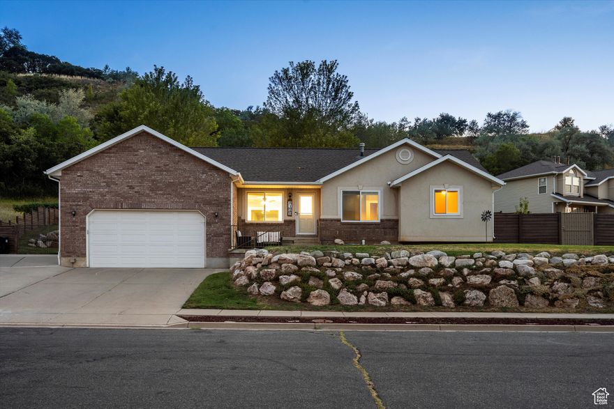 Soak in panoramic mountain views from the front patio of this amazing South Weber home! Inside, you'll love the open floor plan, silestone countertops, and a big, welcoming family room downstairs. The location is a dream-tucked away in a quiet cul-de-sac just outside the "South Weber wind zone," with quick access to Weber and Davis County hotspots. Out back, the large semi-private yard is perfect for relaxing or entertaining, complete with premium petrified-wood-style concrete fencing, decorative steel gates, and plenty of wildlife sightings. Add in a newer 30-year roof, a tall garage, and a double-wide RV pad, and this place checks all the boxes.  All the windows and upstairs flooring were replaced in 2024, and the primary bath got a full reno in 2023.  The back patio was expanded in 2024 with new stairs and extra RV space, and the stucco was repaired to keep things looking great! For a little extra charm, you'll find a cherry and peach tree in the backyard. With all these updates, views, and that South Weber lifestyle, this one won't last long-schedule your showing today!