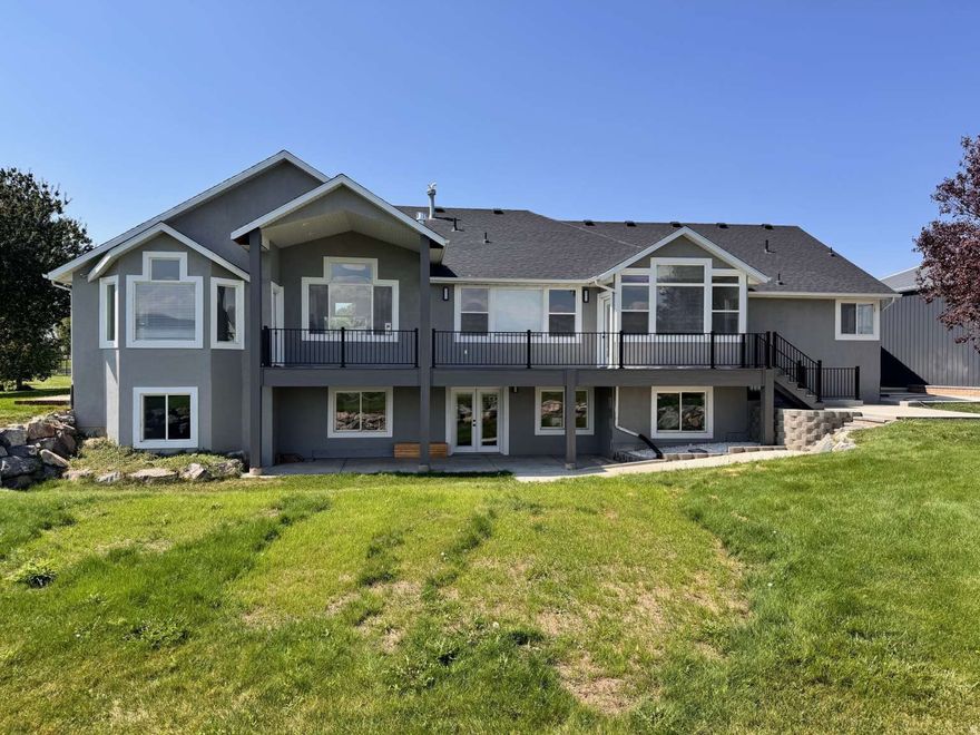 Bring your horses!! Beautiful fully remodeled (inside and out) 5000 square-foot home on 5.25 acres. Includes water rights, alfalfa field, and 1900 square-foot shop. Grow your own alfalfa for your livestock with an average of 200 bales of hay per cutting. This property includes 10.5 shares of water from the Highline Canal pressurized water system.  The beautiful home has a downstairs apartment that can be separated from the upstairs with the close of a door. You could live upstairs and use the basement as a mother-in-law apartment or rent it out to a friend to help with the mortgage or whatever suits your fancy!  The home has been completely upgraded with a new 97% high efficiency, furnace and AC condenser. It has also been updated with a new on-demand water heater and water softener.  You will love the kitchen on the main floor with custom-made white oak cabinets and pure white uppers with inset glass and so much more.