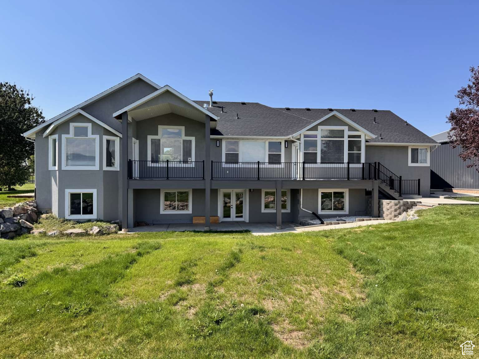Bring your horses!! Beautiful fully remodeled (inside and out) 5000 square-foot home on 5.25 acres. Includes water rights, alfalfa field, and 1900 square-foot shop. Grow your own alfalfa for your livestock with an average of 200 bales of hay per cutting. This property includes 10.5 shares of water from the Highline Canal pressurized water system. The beautiful home has a downstairs apartment that can be separated from the upstairs with the close of a door. You could live upstairs and use the basement as a mother-in-law apartment or rent it out to a friend to help with the mortgage or whatever suits your fancy! The home has been completely upgraded with a new 97% high efficiency, furnace and AC condenser. It has also been updated with a new on-demand water heater and water softener. You will love the kitchen on the main floor with custom-made white oak cabinets and pure white uppers with inset glass and so much more.