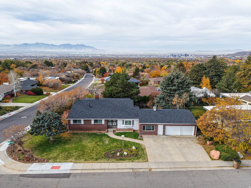OPEN HOUSE SATURDAY 11/22/25 from 12-2pm!!! | This warm and inviting home in coveted St Mary's neighborhood features over 3700 square feet, breathtaking valley views in back, & stunning mountain views in front | Pride of ownership shows as this home has been lovingly cared for by the same owners for over 60 years | Gorgeous original wood floors with a new natural stain, new paint, and brand new carpet | Wonderful layout with spacious living room with fireplace, formal dining, and large kitchen area with an additional living space & fireplace | 3 exterior doors upstairs give easy access to the covered deck that runs the length of the house | Ample sized bedrooms throughout | Awesome daylight basement with large family room, wet bar, two-way fireplace, large office/den, and two brand new bathrooms with quartz countertops, subway tile showers, and LVP flooring | Basement has two exterior doors to backyard and has great potential for a Mother-in-Law apartment or separate living space/ADU | Great storage in garage and basement |New roof March 2025 | Perfect location near Foothill, Parleys Canyon, University of Utah, and SLC