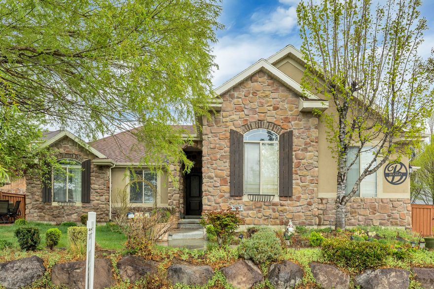 Welcome to this beautiful rambler located in the highly sought-after Traverse Mountain community. This home features beautiful custom white cabinetry, granite countertops, hardwood floors, and upgraded carpet throughout-creating a warm and stylish living environment.  The spacious family room offers a cozy fireplace and provides direct access to an inviting patio and terraced backyard, perfect for relaxing or entertaining. Enjoy the peaceful ambiance of your own private outdoor retreat, complete with a tranquil waterfall and a putting green for added fun.  Residents of Traverse Mountain enjoy access to exceptional amenities, including biking and walking trails, tennis courts, playgrounds, and a community pool and clubhouse. Conveniently located near shopping, dining, and freeway access, this home offers both comfort and convenience.  Don't miss your opportunity to see this incredible home-schedule your showing today!  Square footage figures are provided as a courtesy estimate only and were obtained from county records. Buyer is advised to obtain an independent measurement.