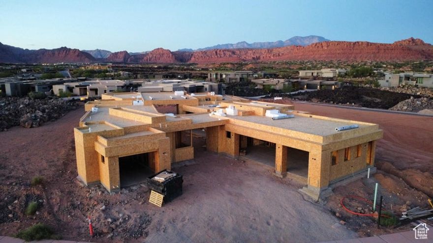 Welcome to this Split Rock custom build that is an exceptional residence in the prestigious Entrada community, offering 4,926 square feet of refined living space. With 5 bedrooms, 5.5 bathrooms, and a spacious 4-car garage, this home blends modern elegance with timeless comfort. Walls of glass frame the extraordinary red rock and mountain vistas, creating a seamless connection between indoor living and the breathtaking natural surroundings. The open-concept design features expansive living areas, a chef's kitchen with top-tier finishes, and thoughtfully designed spaces for both entertaining and relaxation.  Each bedroom offers its own private ensuite, ensuring comfort and privacy for family and guests alike. The primary suite is a retreat of its own, with stunning views and a spa-inspired bathroom An incredible outdoor living space extends the home's lifestyle to the desert landscapeperfect for relaxing, entertaining, or dining beneath Entrada's signature sunsets. Whether gathering with friends or savoring quiet moments, this home captures the very best of luxury living.