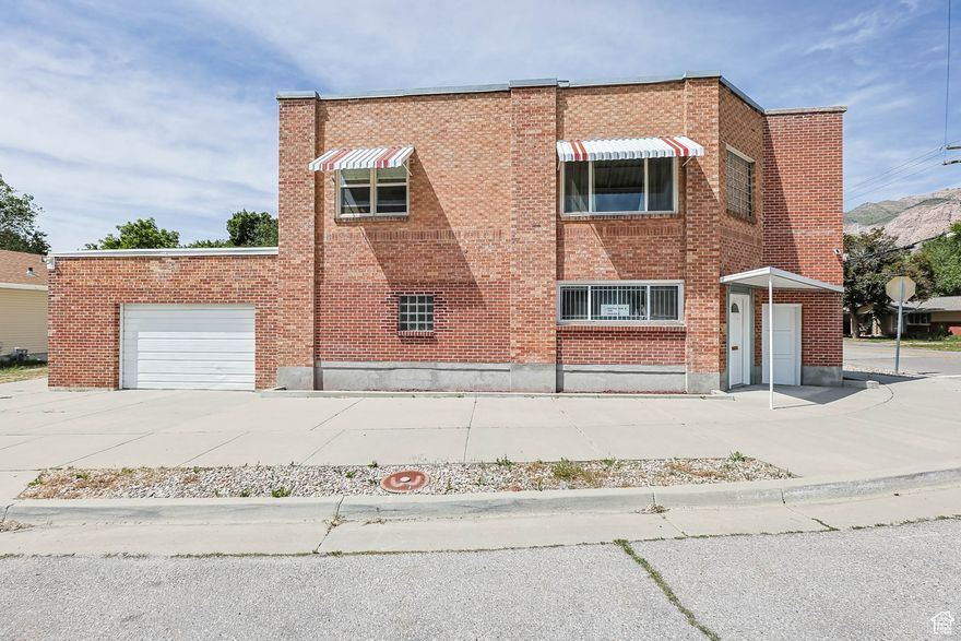 Historical Mixed-Use Building! (former Pennywise Market) * Fantastic Location across from Lorin Farr Park! * Great Investment for Cash Flow  Currently Commercial on Main Floor & Apartment Upstairs * Main Floor Office Space with a Reception Area, Private & Open Rooms, a Kitchen,  Bathroom, Plus a Huge Conference/Work Room (split to more separated offices if needed) * The Upstairs is a Large 3 -4 Bedroom Apartment with Mountain & Park Views * Lots of Charm & Natural Light with a Separate Entrance * Oversized Garage Could Fit 4 Cars * The Whole Building is in Excellent Condition with Updated Paint and Carpet * Freshly Painted Kitchen Cabinets in Apartment * Updated Windows * Endless Possibilities for This Property! * Main Floor Would Be Perfect for a Small Business (Real Estate, Salon, Spa, Insurance, Management, Taxes, Counseling, Physical Therapy, or Whatever You Do) * Rent Out Any Extra Space or Rooms * OR Convert the Main Floor to a 2nd Apartment * The Park (where scenes from The Sandlot were filmed) Features: a Pool, Water Slides, Grass Area with Playground, Large Pavilion, Skate Park, & Ogden River Parkway Trail! * Just a  Block Down from Ogden Pioneer Days Rodeo Stadium * Check out the Photos of the Park * Ask About the Residential Homes to the West and to the North & a Bulk Discount to Buy All Three! * You Can Control the Whole Corner! *