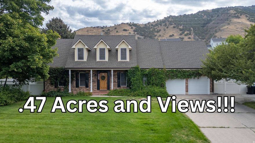 Beautiful 2-story home built in 1983 with classic charm, surrounded by mature vines on nearly a half-acre. Enjoy amazing views of Cache Valley! Remodeled basement with wood stove and great storage. 3 attics! Features include a gas fireplace, step-down family room, new fridge, gas stove, electric oven, new A/C, and new garage door. Fruit lovers will appreciate the apple, pear, and bing cherry trees, plus grapevines, raspberries, blackberries, and rhubarb. Concrete footings under the fence add durability and protection. Great neighborhood, spacious yard, and inviting front porch-this home offers comfort, character, and beauty inside and out! Buyer to verify all. Don't miss the 3D tour