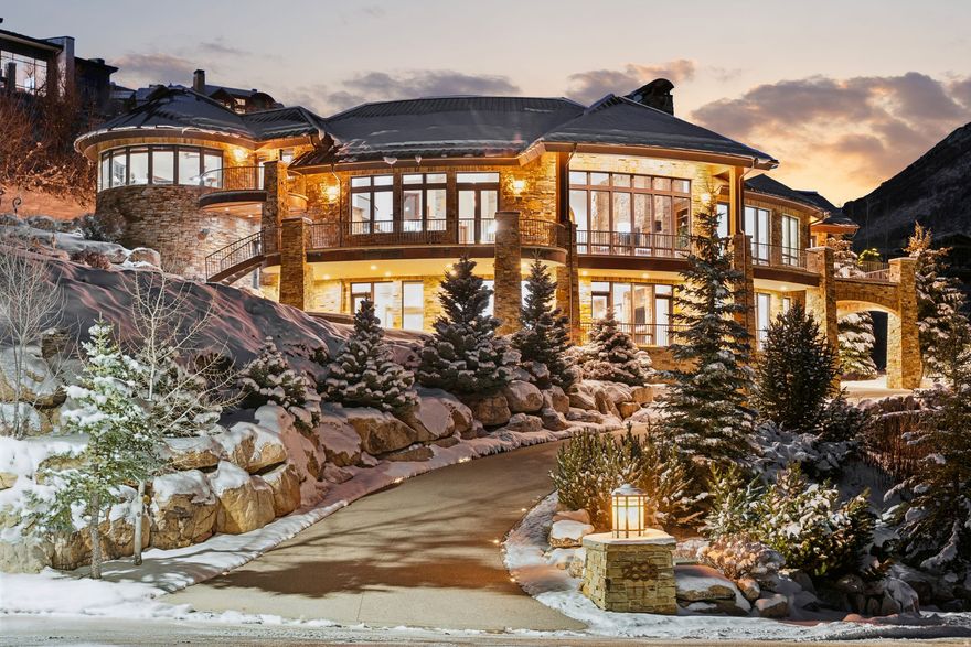 Experience a true ski-in/ski-out residence in Deer Valley with breathtaking views of the Jordanelle Reservoir. Built by renowned builder Thomas McFee, this home showcases exceptional craftsmanship and a thoughtfully designed floor plan. The main level features an open-concept living and kitchen area, a luxurious primary suite, and an additional ensuite bedroom. The chef's kitchen is equipped with top-of-the-line appliances, a large pantry, and a pizza oven. The upper level includes a large dedicated office with expansive views. The lower level offers a second living area with wet bar, three ensuite bedrooms, a ski prep room, theater, additional office space, and flexible space ideal for wine storage. Oversized two-car garage designed for large SUVs, with the ability to accommodate up to four vehicles. With five ensuite bedrooms, eight bathrooms, and direct ski access, this home delivers elevated mountain living in one of Deer Valley's most desirable settings. Located within the coveted Deer Crest community, residents enjoy privacy amid stunning alpine surroundings, with quick access to Deer Valley Resort, the Jordanelle Reservoir, and Main Street Park City-just minutes from the Heber Valley private airport and approximately 40 minutes to Salt Lake City International Airport. Please contact us to schedule a private showing of this exceptional home.