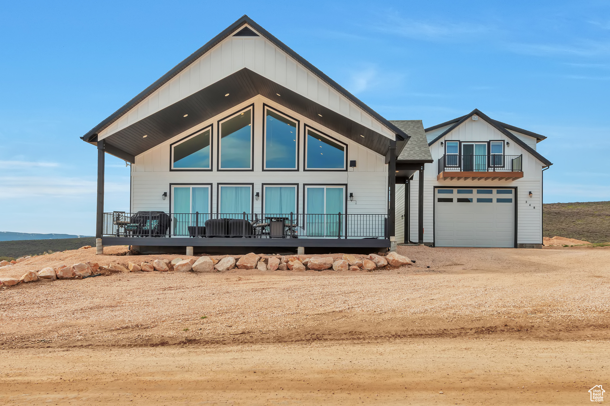 Stunning Bear Lake views! This spacious 4,800 sq ft home offers 5 bedrooms, 6 baths, and is fully furnished-ready for you or your guests. The property is a successful short-term rental and includes a detached garage with an oversized door, RV hook-up, and a cozy apartment/additional living space above. The main home features a beautiful great room, with plenty of room for gathering, large bedrooms, a fun loft with bunk beds, and a covered deck perfect for enjoying panoramic lake views. The backyard is designed for entertaining, and everything is meticulously maintained. All furniture and furnishings are included. You can rent it out immediately or keep it as your private getaway. As a property owner here, you can purchase an Ideal Beach membership for access to Bear lake sandy beachfront, two pools, lakeside playground, mini golf, sport courts, and more. Located just minutes from Utah State boat ramps-ideal for endless lake adventures. Don't miss this rare opportunity to own a turnkey Bear Lake retreat!