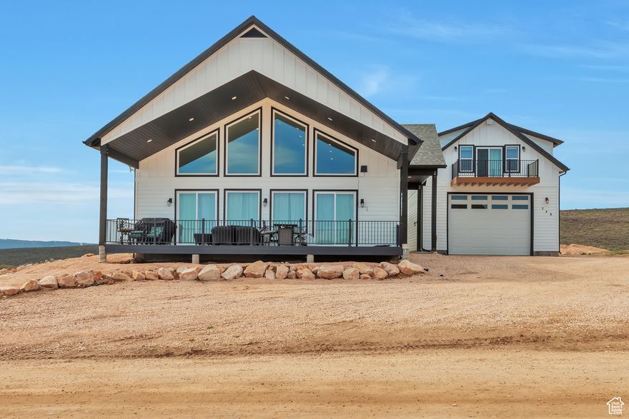 Stunning Bear Lake views! This spacious 4,800 sq ft home offers 5 bedrooms, 6 baths, and is fully furnished-ready for you or your guests. The property is a successful short-term rental and includes a detached garage with an oversized door, RV hook-up, and a cozy apartment/additional living space above. The main home features a beautiful great room, with plenty of room for gathering, large bedrooms, a fun loft with bunk beds, and a covered deck perfect for enjoying panoramic lake views. The backyard is designed for entertaining, and everything is meticulously maintained. All furniture and furnishings are included. You can rent it out immediately or keep it as your private getaway. As a property owner here, you can purchase an Ideal Beach membership for access to Bear lake sandy beachfront, two pools, lakeside playground, mini golf, sport courts, and more. Located just minutes from Utah State boat ramps-ideal for endless lake adventures. Don't miss this rare opportunity to own a turnkey Bear Lake retreat!