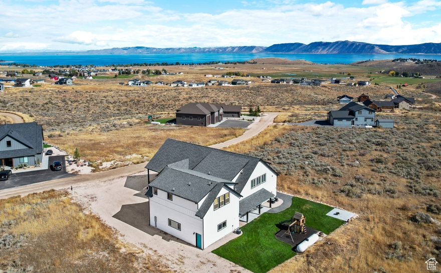 Stunning Bear Lake views! This spacious 4,800 sq ft home offers 5 bedrooms, 6 baths, and is fully furnished-ready for you or your guests. The property is a successful short-term rental and includes a detached garage with an oversized door, RV hook-up, and a cozy apartment/additional living space above. The main home features a beautiful great room, with plenty of room for gathering, large bedrooms, a fun loft with bunk beds, and a covered deck perfect for enjoying panoramic lake views. The backyard is designed for entertaining, and everything is meticulously maintained. All furniture and furnishings are included. You can rent it out immediately or keep it as your private getaway. As a property owner here, you can purchase an Ideal Beach membership for access to Bear lake sandy beachfront, two pools, lakeside playground, mini golf, sport courts, and more. Located just minutes from Utah State boat ramps-ideal for endless lake adventures. Don't miss this rare opportunity to own a turnkey Bear Lake retreat!