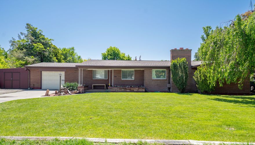 This charming all-brick single-level home is located in a historic neighborhood in Lehi. It features a spacious yard and offers excellent indoor-outdoor living. The property is within walking distance of downtown Lehi, including schools, the library, shops, and restaurants. Additionally, it provides easy access to I-15 for convenient commuting. The home includes RV parking, a separate workshop, and a new roof installed in 2018. Buyers and buyer's agents to verify all information.