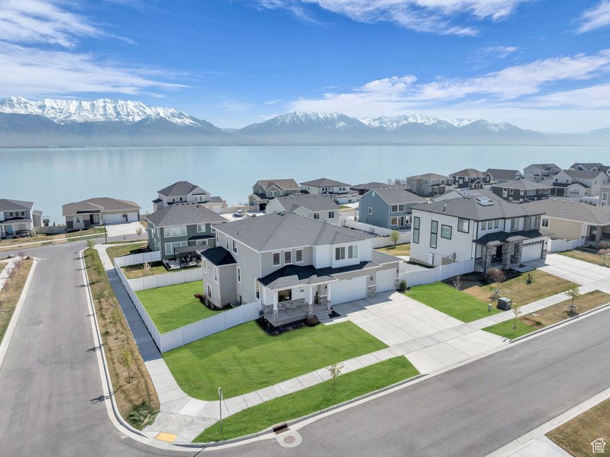 *PRICE SLASHED* Step into luxury with this stunning former MODEL HOME, designed with the finest upgrades and craftsmanship at every turn. Built to impress, this residence boasts countless premium features, including custom kitchen cabinetry, an oversized island, and expansive windows that flood the space with natural light. Designer light fixtures, custom finish carpentry, and built-in closet organizers add elegant touches throughout, while the upgraded laundry room & mudroom provide both style and functionality. A versatile den/office space offers breathtaking views, creating the perfect work-from-home retreat. Enjoy beautiful lake & mountain views from nearly everyroom in the home. The walk-out basement is 40% finished (just received 4-way inspection from city) presents endless possibilities; for a future mother-in-law suite, Airbnb rental, or additional living space. Outside, the fully landscaped yard is fully fenced, offering privacy & room to relax or entertain. Nestled in a the coveted Mallard Bay development with Utah Lake access, this home is more than just a place to live-it's a lifestyle. Don't miss your chance to own this meticulously upgraded gem. Schedule a showing today and see for yourself why this home checks all the boxes! Sq ft figs estimated from co. recs.  Buyer to verify.