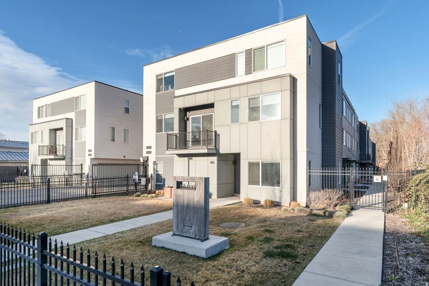 Experience modern urban living at The Ellie, a thoughtfully designed gated community by CW Urban. This contemporary townhome features a bright open-concept layout with stainless steel appliances, gas range, and bar seating that flows seamlessly into the main living and dining areas. Large windows bring in abundant natural light and create an inviting space for everyday living or entertaining. Upstairs you'll find two spacious bedrooms, each with its own private en-suite bathroom, offering comfort and privacy. The lower level provides a flexible space ideal for a home office, gym, or additional living area. Enjoy the convenience of an attached two-car garage and low-maintenance living just minutes from Downtown Salt Lake City, SLC International Airport, restaurants, shopping, and quick freeway access.