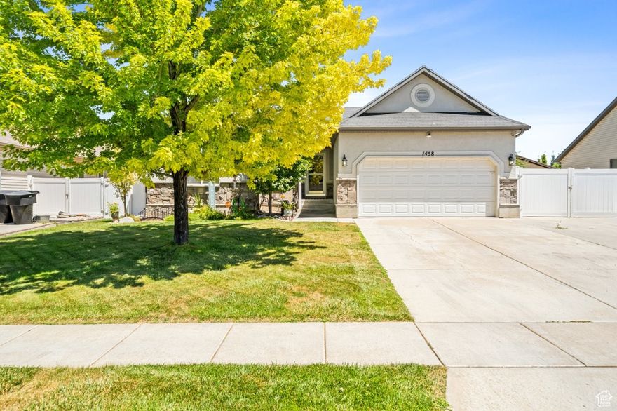 Charming Clinton Rambler!   Step into a bright, open floor plan perfect for both everyday living and entertaining. The spacious kitchen boasts a center island, custom pull-out drawers, a pantry, and plenty of gathering space. Hardwood and tile floors, vaulted ceilings, and main-level laundry add both style and convenience.  The inviting primary suite features a walk-in closet, separate tub and shower, and a relaxing retreat feel. Cozy up by the striking rock fireplace, and enjoy thoughtful upgrades throughout-two-tone paint, ceiling fans, 2" blinds, and more.  Outside, you'll love the RV parking, vinyl fencing, auto sprinklers, and secondary water for easy upkeep. The finished basement offers a beautiful family room, giving you even more space to spread out. Trampoline is included but can be removed.  Don't wait-call today to schedule your private showing!