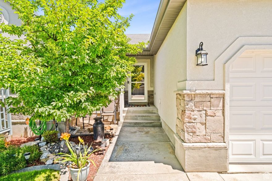 NEW PRICE REDUCTION! Welcome home to this beautifully maintained 5-bedroom, 2-bathroom Clinton rambler featuring a bright, open floor plan designed for both comfortable everyday living and effortless entertaining. The newly updated kitchen is the heart of the home, offering a large center island, custom pull-out cabinetry, pantry, and plenty of space to gather.  Vaulted ceilings, hardwood and tile flooring, and main-level laundry add both style and convenience throughout. The private primary suite provides a relaxing retreat with a walk-in closet, separate soaking tub, and walk-in shower.  The inviting living area is anchored by a striking rock fireplace, creating a warm and cozy atmosphere. Additional upgrades include two-tone paint, ceiling fans, and 2" blinds.  The finished basement features a spacious family room, giving you even more room to spread out, relax, or entertain.  Step outside to a beautifully landscaped yard with RV parking equipped with 220-amp power (located in garage), vinyl fencing, auto sprinklers, and secondary water for easy and affordable maintenance. Trampoline included (can be removed if desired).  This move-in-ready home offers space, upgrades, and outdoor features buyers are searching for-schedule your private showing today!