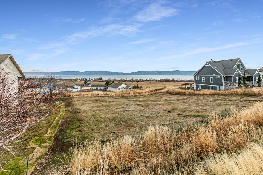Breath-taking, sweeping view of Bear Lake. Stream location should prevent building. Sharper drop-off east of lot (behind) maintain view, privacy. Upscale homes in subdivision. Close to Garden City; restaurants, docks, water. Close to Idaho border.