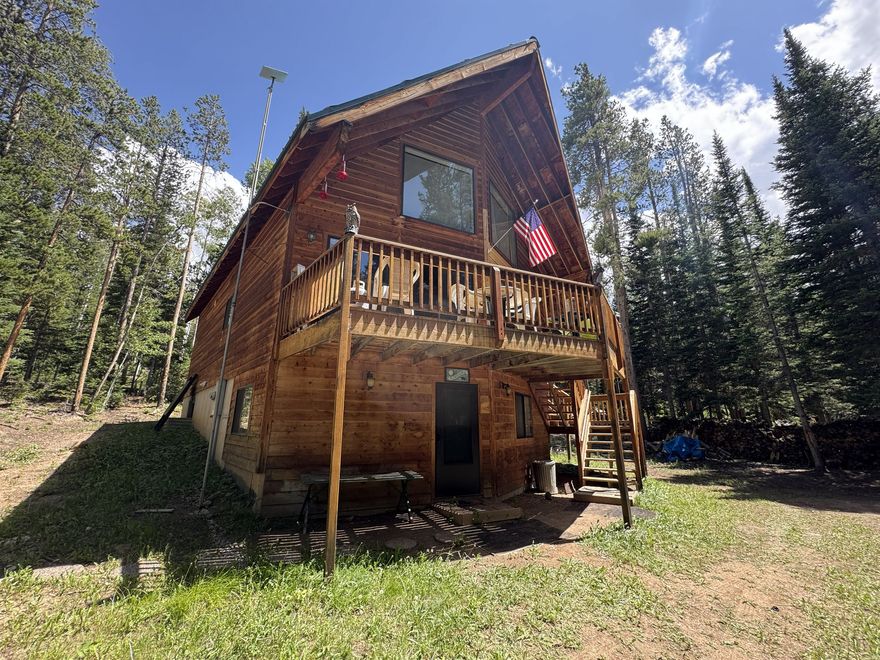 A slice of heaven, this cabin tucked away in the whispering pines offers an easy-to-access escape from busy lives and constant interruptions. Situated on a 3.37-acre parcel within the Uintalands gated community, this spacious oasis is a mere 60 to 90-minute drive from Salt Lake, depending on weather and traffic. In that short period of time, one can be transported into another world--a world filled with fresh, clean air, towering pines and Quaking Aspens as well as the opportunity to listen to the sounds of silence while savoring nature at its finest! This one-owner family cabin was lovingly constructed and designed to accommodate large gatherings or small intimate groups. As the location on Memory Lane implies, so many options abound for creating lasting memories. The main floor is open concept with room to gather, eat, play games or watch movies. Six bedrooms, two baths and a loft with a bunkhouse set-up that overlooks the great room provides a variety of sleeping arrangements. Added to that are the panoramic views from the two-story floor-to-ceiling windows in the great room and through the sliders out to the wrap deck. The ground level features a separate outside entry into the rec room with a pool table and four of the bedrooms and a bath. A "place for all seasons," there are any number activities to select from, including outdoor recreation to relaxing around the cozy wood-burning stove. Year-round water availability, underground power lines and Starlink internet expands the possibilities for working remotely, hanging out or just binge watching. Experience dark skies around one of the two approved concrete fire pits on the property. There is an incredible amount of privacy, as neighboring cabins are on equally-large lots yet, there is also a sense of community. Bring your toys, sports equipment, ATVs, bikes, fishing poles and imagination to take advantage of all of the community amenities. Those include a private fishing pond, a private archery/shooting range and access to ATV/biking/hiking trails to name a few. This property is more than a "cabin." It offers a lifestyle in a rustic environment with modern conveniences that is within driving distance at a moment's notice, even in winter. With the common area parking being plowed, owners can park trailers and access cabins via snowmobiles or tracked vehicles. The sellers have cleared the vegetation around the cabin to allow for ample parking as well as to assist with fire prevention. The cabin is turn-key property that comes furnished and ready for move-in. Some personal property and sentimental items to be excluded. Property details and square footage figures provided are deemed reliable; however, buyers and agents are encouraged to verify all. Short-term rentals are not allowed.