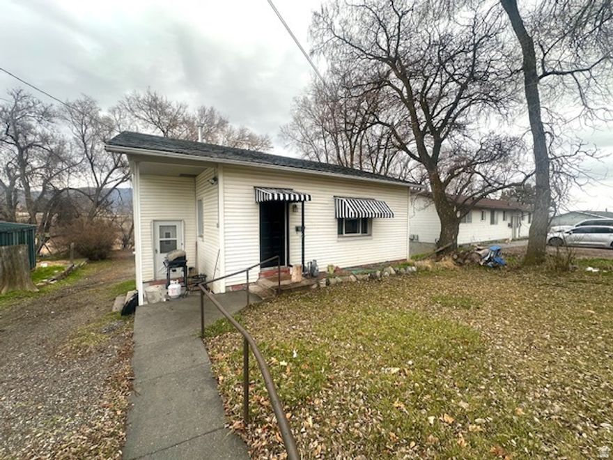 Tucked at the end of a quiet road, this inviting 3-bedroom, 2-bath home offers comfort, privacy, and convenience. Mature trees provide shade and a sense of seclusion, while updated flooring and a refreshed bathroom give the interior a clean, modern feel.  The main-level bedroom adds flexibility, with two additional bedrooms in the basement for separation and space. A bright, open kitchen and dining area welcomes natural light, and the extra-large living room offers room to gather, relax, or even incorporate a formal dining space.  With a storage shed and close proximity to grocery stores and town amenities, this home blends peaceful living with everyday convenience.