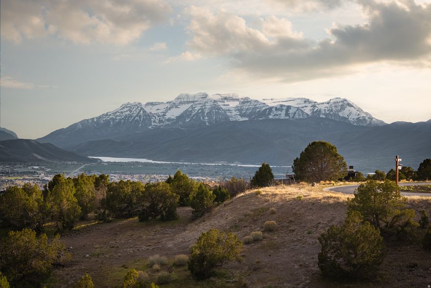 This .94-acre homesite is ideally positioned at the end of a quiet cul-de-sac, offering a rare combination of privacy, expansive views of the Wasatch Back from Mt. Timpanogos to Deer Valley ski runs, and consistent all-day sun. Set along the western slope of Heber Valley, the elevated setting captures both the surrounding mountains and the open valley below.  The generous building envelope provides flexibility to design a custom home that takes full advantage of the views, light, and natural topography. Whether you envision a primary residence or a mountain retreat, this setting allows for a thoughtful, well-oriented build that maximizes both indoor and outdoor living.  A location like this-private, view-oriented, and easy to build on-is increasingly limited within the community.