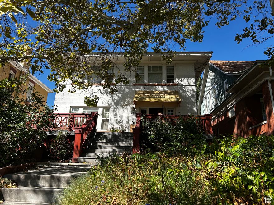 Back on the market! A super cool house in Salt Lake City's historic district. Massive sized rooms on the main floor, entry, living room, formal dining and kitchen. 5 bedrooms upstairs, with room to create another bathroom and laundry room. A second stairway connects the kitchen to the "maid's quarters" upstairs. A full apartment in the basement with a separate entrance! Offset your mortgage with rental income. The home has a beautiful setting with lovely perennial flowers and huge trees. A big backyard and a covered drive are items you don't find often with avenues homes. The front porch and brick patio in the back are perfect for lounging and entertaining. This home needs a full remodel.  The after repair value is $1,500,000 and can be confirmed with MLS# 2066385. If you have longed for a big beautiful home in the avenues, Utah's hippest neighborhood - here is your chance. The neighbors are amazing and the whole block has a welcoming feel.
