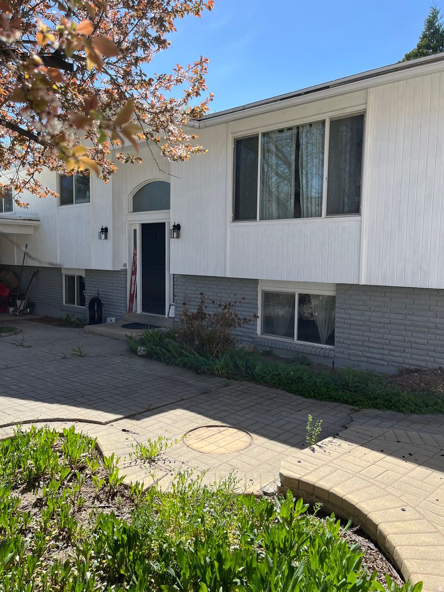 Beautifully updated family home in a safe and quiet mature neighborhood with all the convenience and amenities of Millcreek including a variety of stores, coffee shops and restaurants all within walking distance.  Easy freeway access. The seller has made many improvements including the 2 updated kitchens, a new a/c unit, fresh paint and other tasteful cosmetic changes. There is a separate access to the basement apartment with a full kitchen, storeroom/pantry, bathroom, 2 good sized bedrooms and a large living room with a fireplace.  The basement has above-ground windows making it light and welcoming. Rent out the basement to help pay your mortgage. Seller is also offering seller-financing at a competitive interest rate - call agent for details.  The rear yard has several established fruit trees and bushes and an area for growing vegetables. Buyer/buyer agent to confirm all information provided.