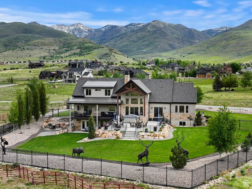 Perfect home for multigenerational living! This beautiful, custom-built mountain modern home in Eagle Ridge sits on the East bench of the Ogden Valley just below Powder Mountain. It offers breathtaking views in every direction. The xeriscaped front yard is uniquely stunning, requires very little maintenance, and is regulated by a smart irrigation controller. The open floor plan features vaulted ceilings highlighted with wood beams. This house provides over 6,400 ft2 of living space with 6 bedrooms, 5 bathrooms, a large office, 2 kitchens, two laundry rooms, two family rooms, and a large bonus room that can be used as flex space. The white oak hardwood floors throughout the upper and main floors provide a clean luxurious feel. With an oversized 3-car garage. The 969+ ft2 of garage space provides plenty of room for vehicles and hobbies. The garages have ample lighting, extra insulation, insulated garage doors, heating and cooling system, and 220V connection.  The main kitchen is dreamy with Dacor appliances including 36" wide built-in fridge and freezer columns, 48" range with built in griddle, a pot filler, and a hidden butler pantry, The kitchen and dining area have sliding glass doors that step out onto the expansive 1,269 ft2 patio and partially covered deck space extending the outdoor dining season. The mud room is designed to accommodate ski equipment and seasonal gear with ample storage space. The primary bathroom has a large soaking tub and a large walk-in shower with two shower heads. Downstairs there is a large family room with a full kitchen.  A separate theater room with surround sound speakers and projector is included. The separate entrance, second kitchen, and laundry could accommodate an ADU with some minor modifications. There are several large closets for storage and a large storage room with built-in shelving. The backyard will entertain all ages and is fully fenced with wrought iron fencing. The yard is large enough to add a pool or sports court. This home is well designed with energy efficient features, automated blinds, 4 HVAC systems on smart controllers, hot water circulation pump, whole house air filtration, Phyn smart water valve, backup Generac generator, 2 laundry rooms, Abode security system, and Ring security camera system. Square footage figures are provided as a courtesy estimate only and were obtained from the Weber County Tax Records. Buyer is advised to obtain an independent measurement.