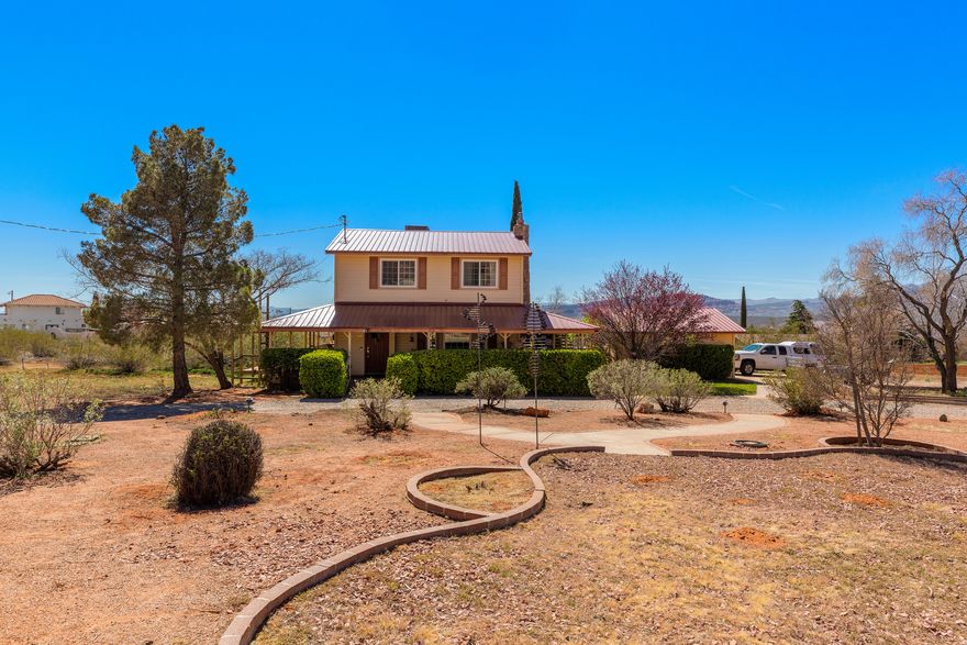 Are you seeking country-style living in the city? This huge 1.73-acre lot will accommodate your chickens, dogs, cats, RVs, and other toys. Cute 2-story country style home with wide open views, 3-beds,  2-baths, a wonderful wrap-around porch, nearly new METAL ROOF, WINDOWS, and SOLAR PANELS. Nestled near the foot of the Big Red Mountain in Ivins, Utah. Perfect for families or anyone eager to get back to basics. Great schools, shopping, and limitless recreation right outside your door. Plenty of room to expand. Need a bigger garage? Guest house? Pool? This place will fit ALL THE ABOVE and more. For those with bigger ambitions, divide this property and develop hard-to-find buildable lots for homes. Or go big and complete a subdivision of needed housing in Ivins.  Wind Sculptures are excluded.  Workshop has power.