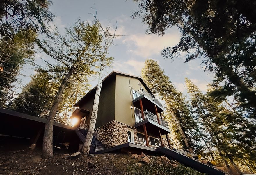 This .50 acre mountain retreat offers the perfect blend of privacy and convenience, just 10 minutes from Woodward and 5 minutes from the highway, yet quiet and secluded without the noise. Surrounded by trees, wildlife, and direct trail access, it's an outdoor lover's dream. Inside, enjoy a bright, open layout with large windows, Recently updated countertops in the kitchen and main floor bathroom, and brand-new carpet throughout (excluding the lower level). Outdoor living shines with a new three-tier balcony and reinforced Trex front deck with a gas line, perfect for entertaining. A detached two-car garage features a 240V EV charger, water softener, overhead storage, plus parking for four additional vehicles. We also have a quote on hand for a heated driveway. Rental Analysis in hand for STR. Square footage is provided as a courtesy estimate; buyer to verify.