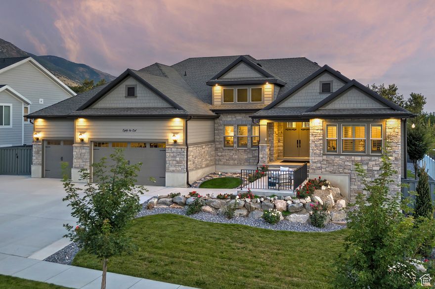Discover an incredible value in this one-of-a-kind luxury rambler, perfectly positioned on an expansive .32-acre lot in a highly coveted East Side neighborhood. From the moment you step inside, you'll experience a sense of comfortable elegance that flows effortlessly through the spacious, open floor plan-ideal for those who appreciate the ease of main-level living. The formal dining room impresses with soaring two-story ceilings and a wall of windows that floods the space with natural light. The gourmet kitchen, as functional as it is beautiful, features a large island with bar seating, abundant cabinetry, upscale appliances including a double oven, a pantry, and a sunlit dining nook. Rich wood floors extend seamlessly into the great room, where a stately fireplace framed by built-in cabinetry serves as a warm and inviting centerpiece. The main-level owner's suite is a private retreat, complete with a spa-inspired bath, a relaxing soaker tub, and a generous walk-in closet. A second ensuite bedroom on the main level offers an equally comfortable accommodation for guests or family. With 10-foot ceilings on the main level and 9-foot ceilings below, thoughtful design and attention to detail are evident at every turn. The fully finished lower level expands the home's versatility, offering a second kitchen, a recreation room, and an exquisite custom cherry-wood theater for unforgettable movie nights. Three additional bedrooms and two full bathrooms complete this remarkable space, ensuring comfort and convenience for all. Outdoors, the property shines just as brightly. An oversized three-car garage and a large RV parking pad provide exceptional flexibility, while two covered porches and a covered deck invite year-round enjoyment. Surrounded by pristine landscaping, the property feels like a private park, boasting breathtaking views of both the mountains and the water. With no rear neighbors and ample room to add a pool, this home offers the ultimate blend of privacy, beauty, and functionality-truly checking every box on your wish list. *Square Footage is provided as a courtesy only. Buyer is advised to obtain an independent measurement and verify all information.*
