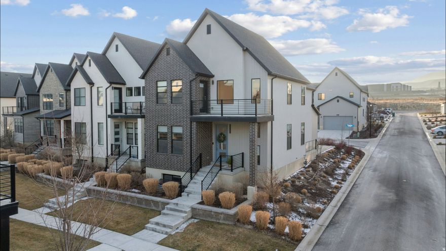 Welcome to this stunning, fully finished Ivory Homes Bergen Grand plan nestled in one of Lehi's most desirable neighborhoods, just off 2100 N and minutes from Redwood Road, I-15, and the new Primary Children's Hospital. Boasting 3 spacious bedrooms, flex room, 2.5 bathrooms, and over 3,100 square feet, this sleek and modern home is designed for both style and comfort. The main level features gray shaker cabinetry, white quartz countertops, a single-basin stainless steel sink, and a full suite of stainless steel appliances. The side patio just off the kitchen offers a private outdoor retreat, perfect for your morning coffee or evening unwind. Upstairs, you'll find all bedrooms, including a spacious primary suite with vaulted ceilings, dual sinks, a walk-in cultured marble shower, and two private balconies, a rare and refreshing feature for elevated living. The fully finished basement adds a huge bonus room ideal for gaming, workouts, or movie nights, offering the ultimate flexibility for your lifestyle. Includes tankless water heater, water softener, reverse osmosis and radon mitigation system. This home blends contemporary design with practical livability in a location that can't be beat. Don't miss this rare opportunity to live minutes from it all, in a home that has it all. Buyer to verify all.  Square footage figures are provided as a courtesy estimate only and were obtained from Utah County.  Buyer is advised to obtain an independent measurement.