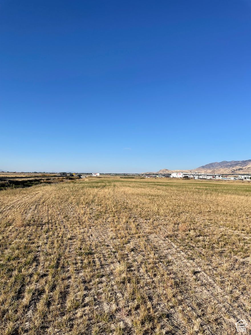 Approximately 6-acres.  Airport Zone.  This property presents a unique opportunity for development, thanks to its high visibility and prime location. Here are some key features and potential uses for the property: From Logan City Development code: Permitted or conditional uses: clinic, medical, dental, or optical, utilities, wireless telecommunication facilities, entertainment, Hotel, motel, office, general business, Office, laboratory, parking, brew restaurant, aviation or transportation. Additional land available.