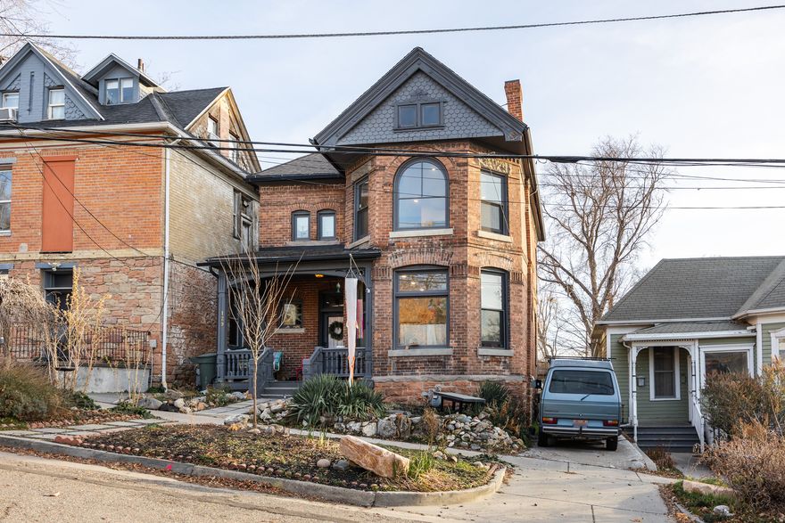Built in 1901 and perfectly located in one of our city's most charming neighborhoods, this historic property is ticking just about every box we can think of. Alongside plenty of original details here, you'll find modern touches and thoughtful updates (from an almost-complete remodel in 2023) that blend beautifully and create the ideal home for anyone. From the curb, it's a dream: the well-maintained brick is complemented by dark grey trim, and a cozy front porch is just begging for a rocker and a glass of lemonade. At just under 2,000 square feet, it's neither too sprawling nor too crowded-3 beds and 3 baths (1 full, 1  and a ) translate to a cozy space for everyone and some privacy when it matters. Nice, high ceilings in the primary living spaces work hand-in-hand with the natural light to lend openness and warmth, and transom windows sprinkled throughout lend some quirk and style. A fully remodeled kitchen is bright and functional, lending plenty of cupboard space, a large island, and all new appliances to your culinary efforts. The primary suite includes an en suite bathroom and takes full advantage of the same bay windows you'll find downstairs, making it feel like something of a quiet sanctuary. Out back, you'll find a patio for nights under the stars and a lengthy, shotgun-shaped back yard that affords plenty of room for your vision, whatever it may be. In terms of location, this one is a winner: a short walk uphill will take you to the Capitol grounds (and some incredible views), and downtown SLC is just a few minutes to the south, which means you've got your pick of our city's best dining and entertainment options. We can't think of a better way to start your 2026 than in this beautiful home.
