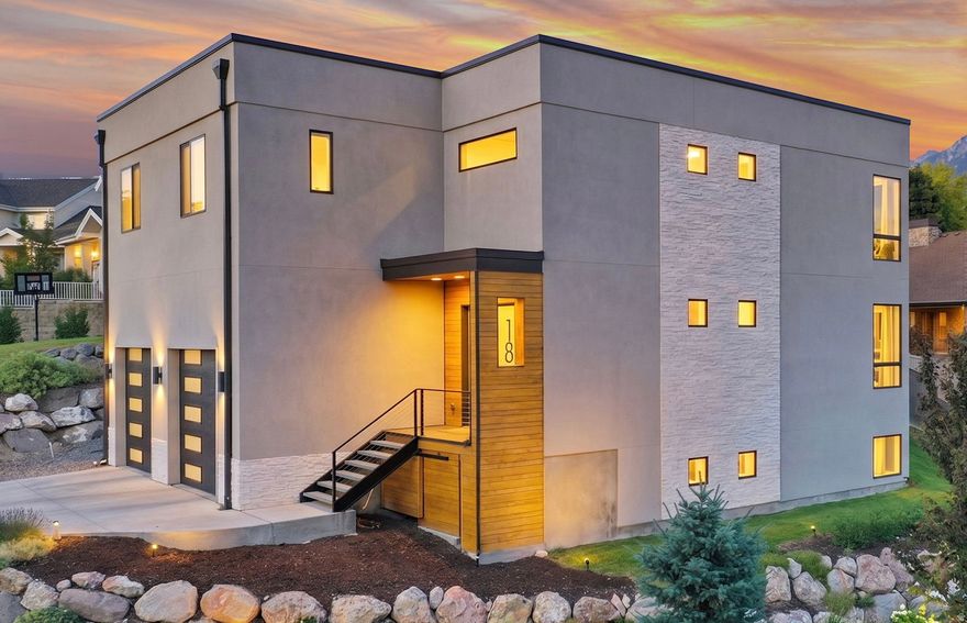 Join us for the open house on April 25 from 11 AM to 1 PM!! Welcome to a private Holladay retreat where refined living meets quiet luxury. Tucked along Orchard Hollow Lane-a secluded road shared by just two neighboring homes-this residence offers a rare blend of tranquility, community, and elevated design in one of the valley's most desirable settings. Inside, the home opens with impressive scale and natural light. Soaring 12-foot ceilings, expansive 10-foot doors, and near floor-to-ceiling windows on the southeast side frame breathtaking views of Mount Olympus-creating a stunning backdrop from the main living spaces and primary suite. The home features five spacious bedrooms, including four upstairs: a primary suite, a beautifully updated secondary master suite, and two large bedrooms connected by a Jack-and-Jill bathroom. The lower level includes an additional bedroom, ideal for guests, office use, or extended stays. At the center of the home, the kitchen is designed for both daily living and entertaining-offering a large island, double ovens, gas cooktop, double-door refrigerator, and a walk-in pantry with butler's fridge. A mudroom and half bath just off the garage add everyday convenience. The updated secondary master suite provides a private, spa-like retreat with a luxury soaking tub and custom closet cabinetry with built-in dresser drawers. The lower level is anchored by a fully equipped, cinema-grade home theater featuring a 150" Severtson Deluxe Series screen, Denon receiver, and integrated surround sound-delivering an immersive, true theater experience at home. Upstairs, a reimagined family room showcases custom wood ceiling beams, designer lighting, and a striking imported mural from Sweden-adding warmth, character, and a unique artistic touch. Outdoors, the backyard offers a peaceful escape with a pergola and string lighting for evening gatherings, along with gas and electrical hookups ready for a future grill or hot tub. Additional highlights include a spacious two-car garage with vaulted ceilings, ample storage, and an extra dedicated parking space. The neighborhood is known for its calm atmosphere and genuinely kind community-quiet and serene both day and night. A rare opportunity to own a thoughtfully designed home with exceptional views, privacy, and timeless appeal in the heart of Holladay.