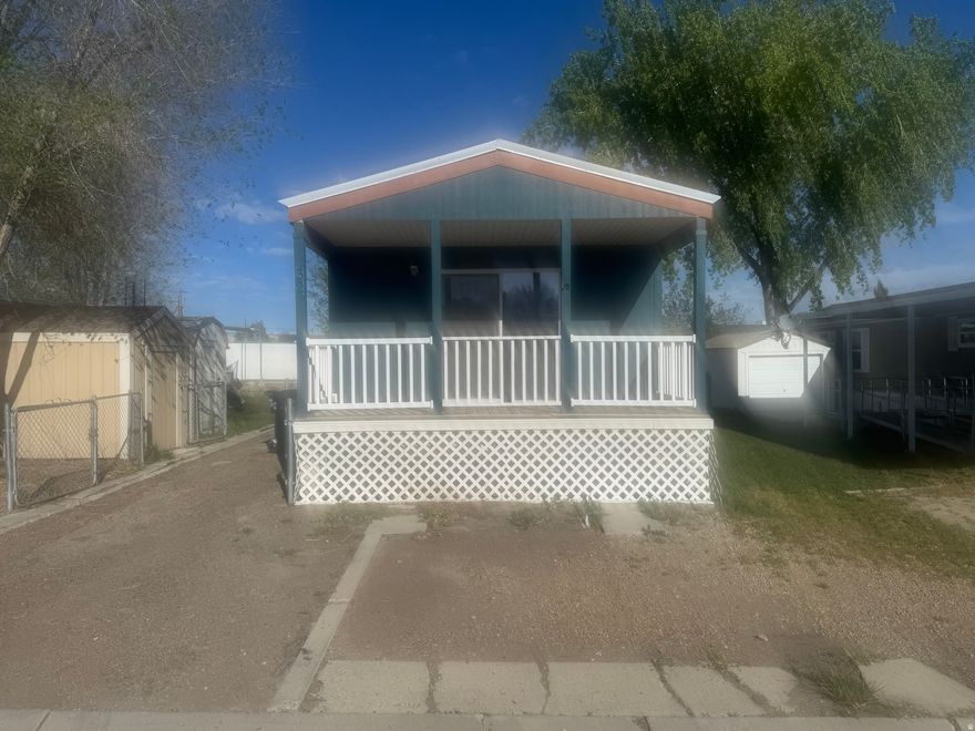 Charming & Affordable Living in Lila Canyon Estates with this  2-bedroom, 1-bath mobile home. This home offers a comfortable and functional layout with thoughtful features throughout. Step inside to find a spacious kitchen with a center island, perfect for meal prep, casual dining, or gathering with friends and family. The cozy living area is highlighted by a fireplace, creating a warm and inviting atmosphere. The home also features a large soaker tub in the bathroom-ideal for relaxing at the end of the day. Enjoy your morning coffee or unwind in the evening on the front balcony with sliding glass door access, adding a great indoor-outdoor living element. Additional highlights include a durable metal roof, fully fenced yard ready for pets, and a storage shed for added convenience.  Please note: This is a mobile home only sale- lot is not included.  Current lot rent is $435/month.