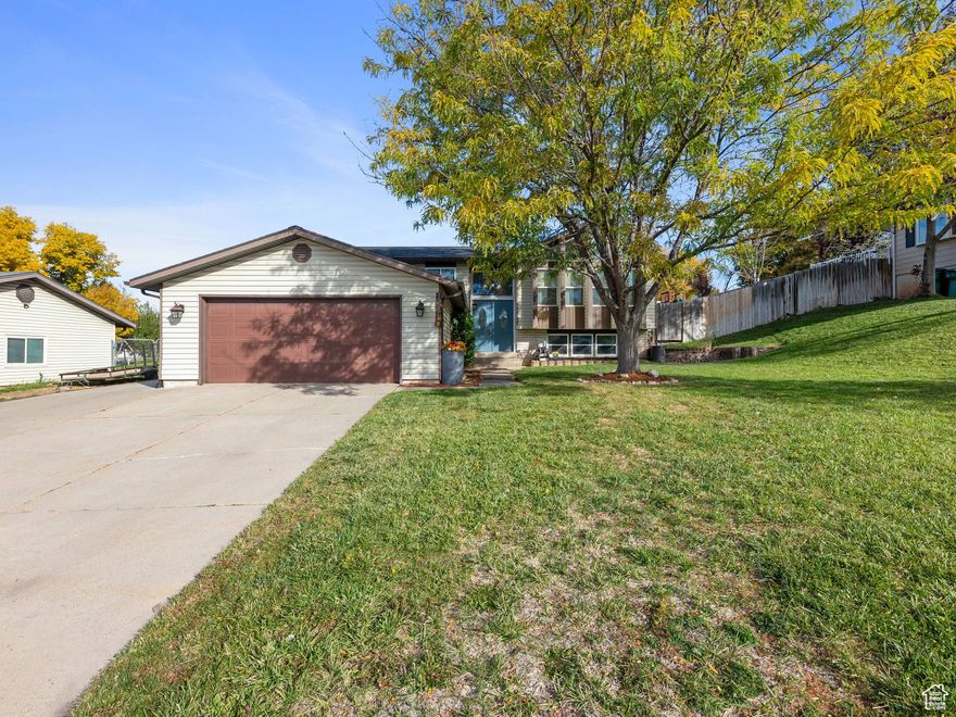 Welcome to this charming home nestled on a quiet street in a wonderful east Layton neighborhood! Clean, open layout, large windows with tons of natural light, updated entrance, vaulted ceiling, spacious rooms, cozy brick fireplace, kitchen equipped with stainless-steel appliances, primary suite, finished lower level, ample closet and storage space throughout, walk-out access to your relaxing backyard, open patio and pergola, grassy space and garden area, concord grapevine and cherry trees, fully landscaped, fully fenced with access gates, and beautiful mountain views. South-facing driveway with RV parking capacity. Affordable utility services and secondary water. New A/C compressor in 2018. New water heater in 2021. New furnace in 2023. New roof, gutters with gutter guards, and solar panels with a 10kW backup battery for the home in 2022 and 2023. For possible future expansion, an additional circuit breaker panel in the garage was also installed. Electricity expense has averaged less than $20 per month! Fantastic location with convenient access to I-15, US-89, Andy Adams Park, Adams Reservoir, Valley View Golf Course, multiple trailheads ideal for hiking, and highly rated schools in the Davis School District. Buyer to verify all information. Call today to schedule your personal tour!