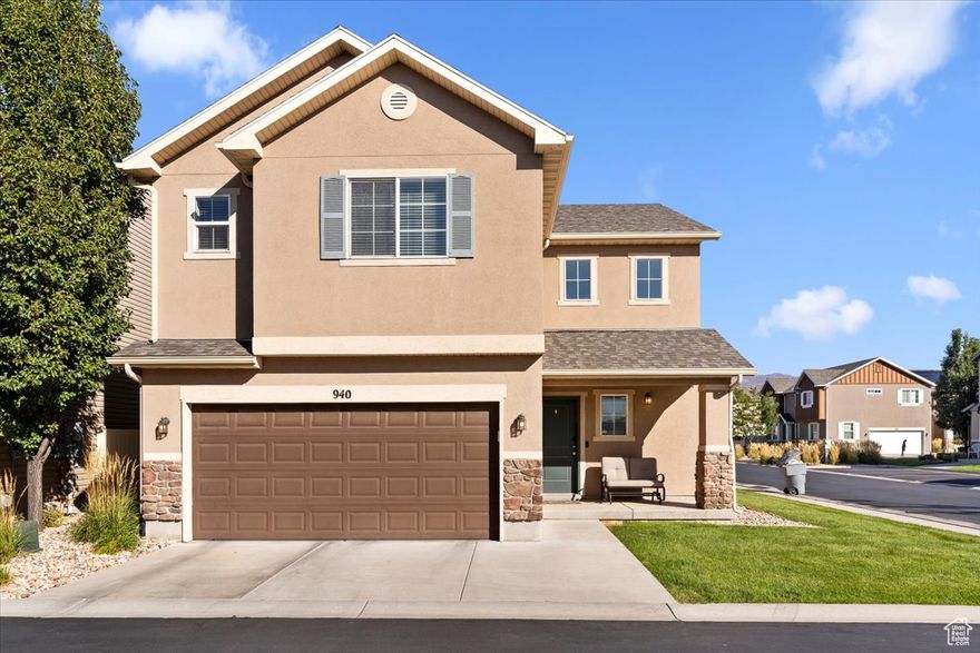 Welcome to this beautifully designed two-story home where comfort meets convenience. The eye-catching exterior showcases a harmonious blend of stone, stucco, and siding, accented by a charming front porch. Step inside to discover a bright and open-concept floor plan featuring a spacious great room bathed in natural light from expansive windows. The gourmet kitchen is a chef's dream, complete with granite countertops, a premium gas range, stainless steel appliances (including a refrigerator), and an oversized walk-in pantry for all your storage needs. The main level also offers a dining area, a convenient half bath, and a functional mudroom-ideal for busy family life. Smart home upgrades such as a Nest thermostat and Ring video doorbell bring modern technology to your fingertips, enhancing both comfort and security. Upstairs, a versatile loft space awaits-perfect for a second family room, home office, or personal gym. The luxurious primary suite features dual vanities, a spacious garden soaking tub, a separate walk-in shower, and a generous walk-in closet. Two additional bedrooms, a full bathroom, and a dedicated laundry room complete the upper level. Outside, enjoy a fully fenced, low-maintenance backyard with lush artificial turf-ideal for play, pets, and peaceful outdoor living. This home is part of a vibrant community offering resort-style amenities, including two clubhouses with swimming pools, a year-round hot tub, fitness center, game room, and front yard maintenance provided by the HOA. Located in the highly desirable Foxboro neighborhood with quick access to I-15, I-215, and Legacy Parkway, you're just 15 minutes from downtown Salt Lake City. Outdoor enthusiasts will love the nearby Legacy Trail for walking, running, and biking, as well as multiple parks including Legacy Park, which features a splash pad, playground, and expansive recreational fields. Schedule your showing today and don't miss out on this incredible opportunity to make this dream home yours! Schedule via Aligned Showings.