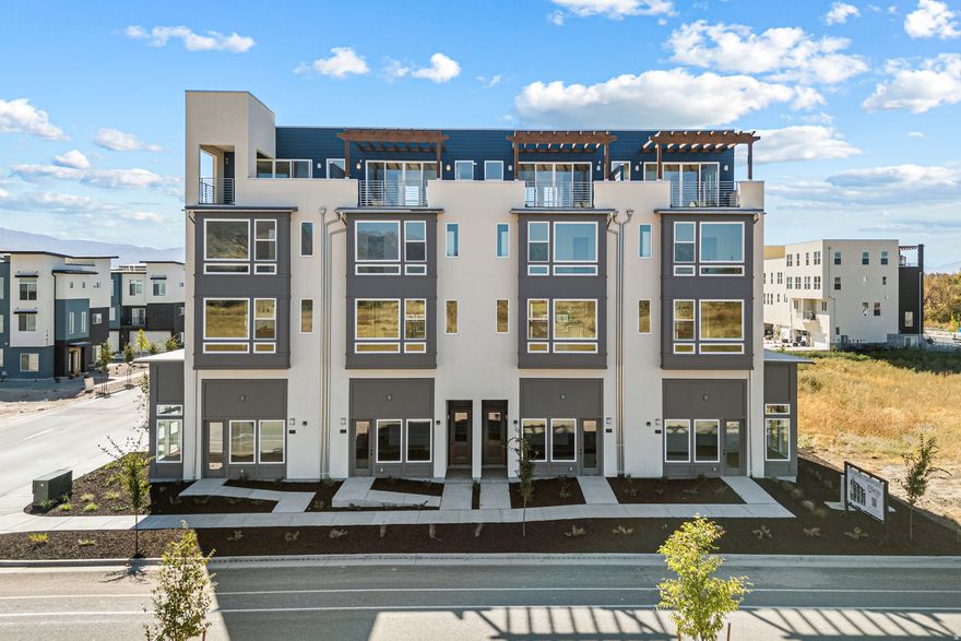 This unique townhome is designed with flexibility and modern convenience. On the main level enjoy a flex space with bath and separate heating/cooling system. Perfect as a private separate office from the rest of the home and is even permitted for commercial use. The second floor is where your main living area shines, featuring a kitchen with a large walk-in pantry, a dining area, and a living room that opens to an exterior deck. On the third floor, you'll find three bedrooms, a laundry room, and a stunning sky room with an upper deck on the fourth floor. This townhome is the perfect choice for those who work from home or want extra space.