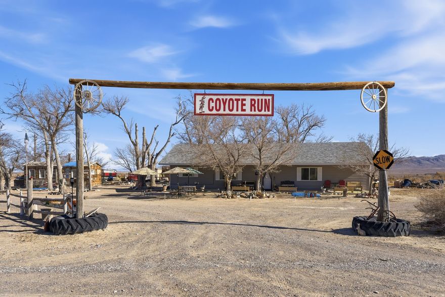 Own your own private desert compound in beautiful Snake Valley, fully set up and ready to enjoy from day one. Unlike most raw desert parcels that require years of planning and infrastructure costs, this 3.21-acre property offers a rare head start with major improvements already in place. The recently built home features a spacious open floor plan, quality finishes, and superior craftsmanship throughout. Constructed with a double-wall system for exceptional insulation and energy efficiency, the home maintains comfortable temperatures year-round while helping keep utility costs low. The inviting family room centers around a wood-burning stove, creating a warm gathering space framed by abundant natural light, mountain views, and surrounding wildlife. Infrastructure is where this property truly shines. A dedicated private well draws directly from the aquifer, a septic system is installed, a utility pole is already on site, propane heat is in place, and newly installed fiber-optic internet offers speeds up to 1 Gbps. No waiting. No development hassle. Outdoor improvements include a massive 40x60 detached garage and workshop on a permanent foundation, complete with a built-in hoist and wood-burning stove. The property is built to accommodate multiple trailers and includes a fenced garden area, additional sheds, and an older home structure. Select outbuildings and personal property are negotiable. Enjoy breathtaking sunrises, endless sunsets, and true peace and privacy with no HOA and wide-open skies. Located near Great Basin National Park, Crystal Ball Cave, Spring Mountain's natural warm springs, and Devils Gate Canyon, this is an ideal basecamp for adventure, remote work, multi-generational living, or a self-sufficient lifestyle. If you've been searching for an off-grid retreat without starting from scratch, this move-in ready property delivers a rare opportunity in one of Utah's most peaceful regions.