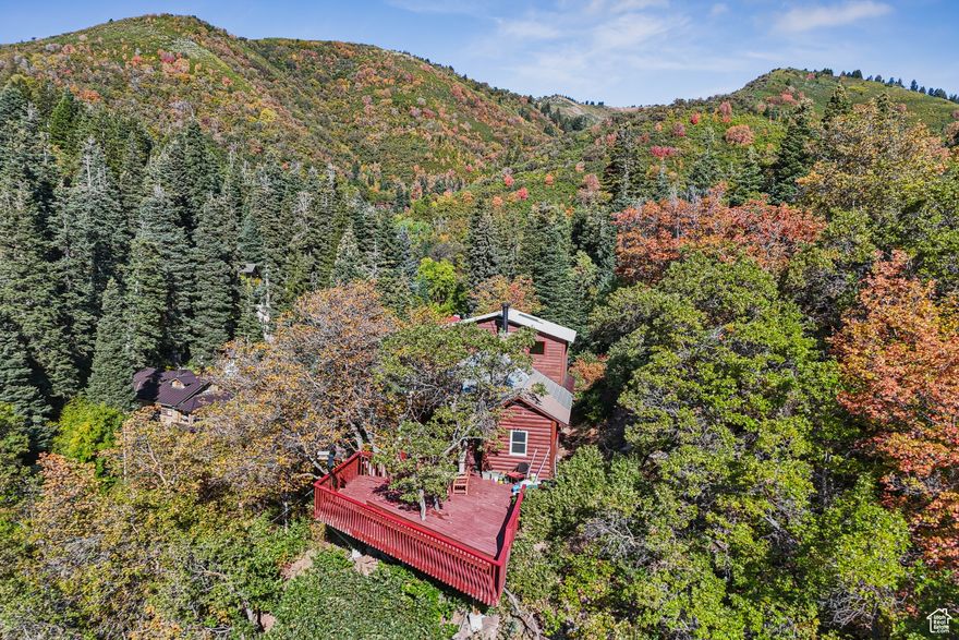 Perched above the treetops in The Groves at Emigration Canyon, this enchanting retreat feels like your very own mountain treehouse. Surrounded by endless forest and wide-open sky, the views here are nothing short of breathtaking - expansive, serene, and ever-changing with the seasons. This charming 2 bedroom, 1 bath home offers a cozy kitchen and great room, along with an upstairs loft office featuring its own separate outdoor entrance. Whether you're seeking a summer escape where quiet mornings and star-filled nights restore your spirit, or a magical winter haven where backcountry skiing begins at your doorstep, this property delivers a lifestyle that is truly away from it all. From its bird's-eye perch in the clouds on your enormous deck, this home invites you to slow down and savor the rare chance to live immersed in nature while still being within quick assess of the University of Utah and all conveniences of Salt Lake City.