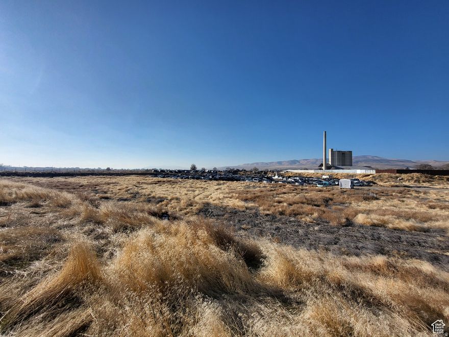 Over 26 acres of commercial/Industrial land for sale in Garland, Utah. This could be a wonderful commercial development opportunity to start or expand your business. Previously used as a metal salvage yard, scales are still in place. Malad River is the east side property line. Seller financing available