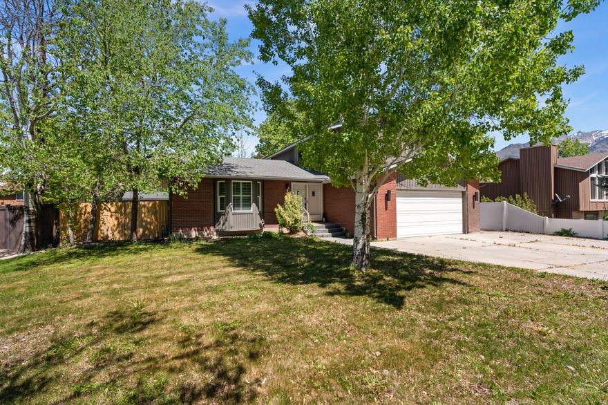 Vaulted ceilings, spa-inspired bathrooms, and a beautifully updated kitchen-this east bench home near Little Cottonwood Canyon is the one you've been waiting for!  Step inside to an open, light-filled main level where soaring ceilings and warm finishes create an immediate sense of space and comfort. The updated kitchen is the true centerpiece, featuring crisp white cabinetry, granite countertops, stainless appliances, and a large island perfect for gathering, entertaining, or everyday living.  The newly updated bathrooms have been thoughtfully designed with a clean, spa-like feel-offering a calm, elevated retreat you'll appreciate every single day.  Upstairs, the bedrooms are bright and inviting, while the fully finished basement adds valuable flexibility with space for a media room, play area, gym, or guest suite.  Outside, mature trees frame a spacious yard with room to relax, host, or simply enjoy the peaceful surroundings.  Located on the highly desirable east bench with quick access to Little Cottonwood Canyon, hiking and biking trails, and world-class skiing-this is where convenience meets lifestyle.  Homes at this price point rarely offer this level of design, light, and location. Come experience why this one stands out.