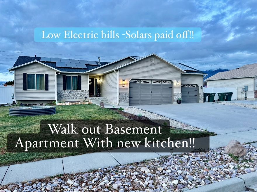 Updated rambler with Beautiful mountain views that offers both function and flexibility in a prime Tooele location! The main level features a stylish open-concept layout that's perfect for everyday living and entertaining. One of the standout features is the spacious 3-car garage-Offering ample space for two vehicles plus toys or a workshop. The downstairs basement with its own private entrance was just converted into a mother-in-law suite or rental unit with the addition of a new kitchen, new kitchen cabinets flooring and lighting plus a new dishwasher to convey. Enjoy lower Utility bills with Recently installed solar panels that have been paid off - all of this with the convenience of being just minutes from shopping, dining, and Tooele's commercial center-while still being close to outdoor recreation and mountain adventures and blocks from A new beautiful park with walking paths and playgrounds. Whether you're looking for multi-generational living, income potential, or simply more space, this home delivers. Property sold as is. Don't miss out-schedule your private showing today! oh and there is no HOA!
