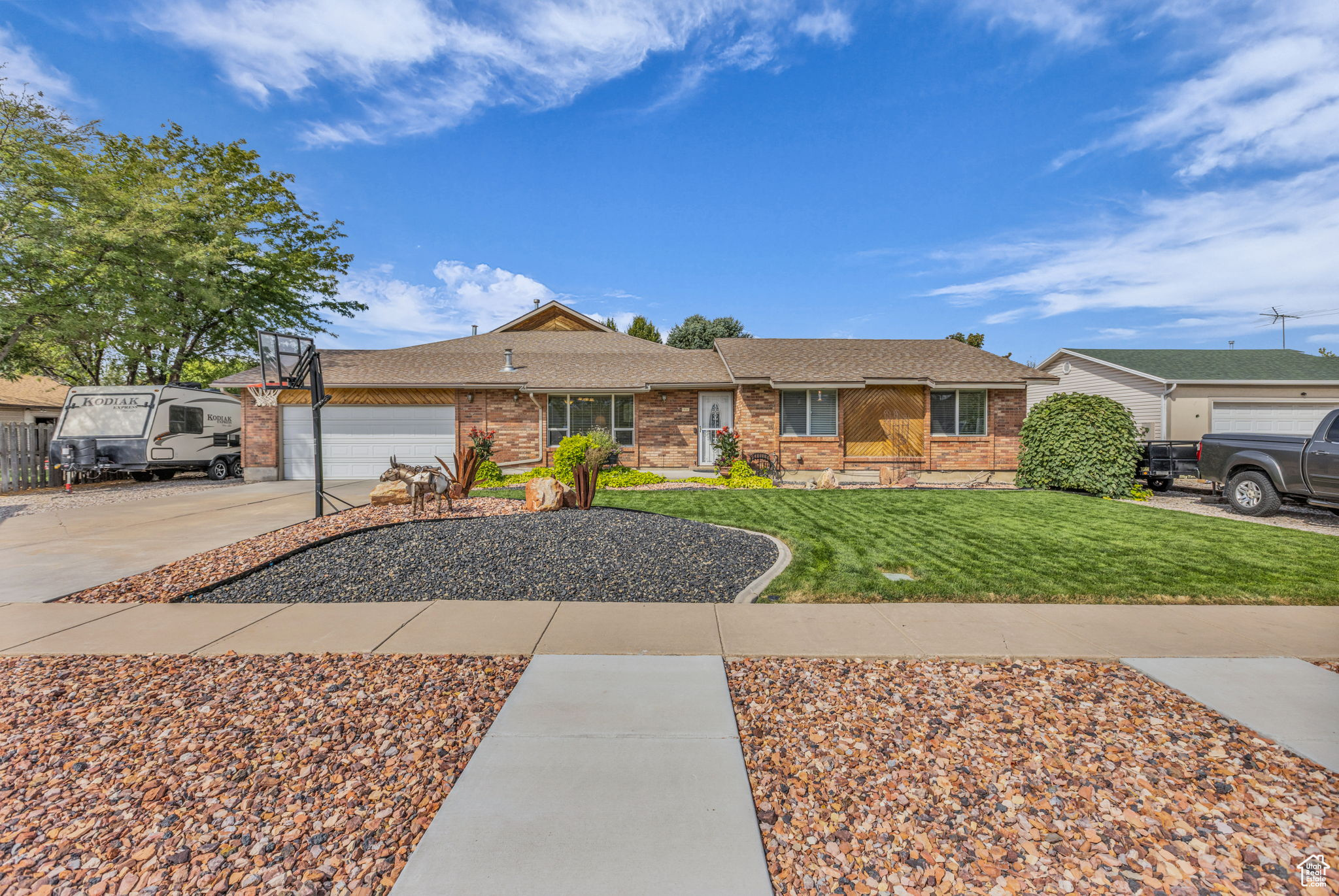 Enjoy small-town living without giving up convenience in this beautifully updated single-level home. Remodeled and expanded in 2008, it features a spacious primary suite with walk-in closet, private bath, gas fireplace and a sliding door that opens to the patio. A cozy den/sitting room connects to the suite, offering a perfect spot for reading or relaxing. The second bedroom also enjoys its own updated bath with striking marble and glass tile. The light-filled great room looks out onto the landscaped yard and flows into a cook's kitchen with custom cabinetry, abundant counter space, spice rack, gas range, and wet bar. With two furnaces, 2 A/C units and 2 gas fireplaces, comfort is ensured year-round. Outside, the wraparound patio with wood-burning fireplace creates a welcoming space for entertaining, while the shed and garden beds provide room to grow. An RV dump is also included for added convenience.All this, just minutes from freeway access.