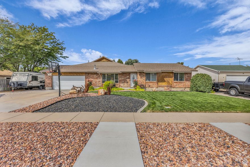 Enjoy small-town living without giving up convenience in this beautifully updated single-level home. Remodeled and expanded in 2008, it features a spacious primary suite with walk-in closet, private bath, gas fireplace and a sliding door that opens to the patio. A cozy den/sitting room connects to the suite, offering a perfect spot for reading or relaxing. The second bedroom also enjoys its own updated  bath with striking marble and glass tile. The light-filled great room looks out onto the landscaped yard and flows into a cook's kitchen with custom cabinetry, abundant counter space, spice rack, gas range, and wet bar. With two furnaces, 2 A/C units and 2 gas fireplaces, comfort is ensured year-round. Outside, the wraparound patio with wood-burning fireplace creates a welcoming space for entertaining, while the shed and garden beds provide room to grow. An RV dump is also included for added convenience.All this, just minutes from freeway access.