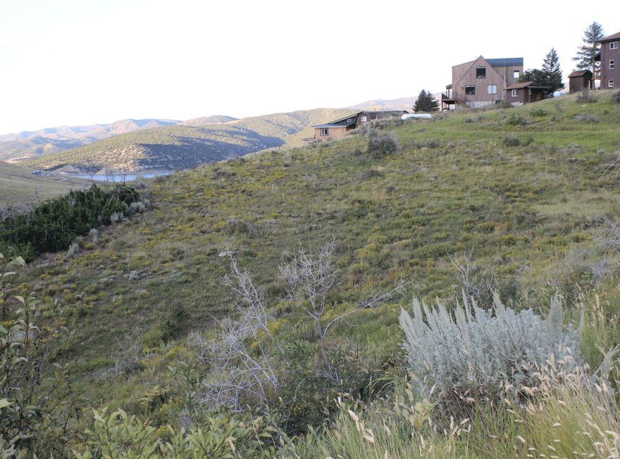 Secure a highly usable homesite just minutes from Rockport Reservoir. This gently sloping lot offers excellent buildability, expansive mountain views, and potential lake views from a future two-story home. Valuable groundwork has already been completed, including a survey, perc test, and available house plans-saving time and upfront cost. Seasonal trailer use is permitted, allowing for immediate recreational enjoyment while planning your future build. Located in one of the more accessible areas of Rockport Estates with year-round access and close proximity to boating, fishing, and outdoor recreation. No water meter is currently installed; however, the seller is actively involved in HOA meetings where future meter availability has been discussed. Buyer to verify. Thoughtfully priced to reflect current water status, this property stands out from other lots without water by offering completed due diligence and added flexibility for use and future planning. An ideal opportunity for buyers looking to secure land now with preparation already in place and potential for long-term upside.
