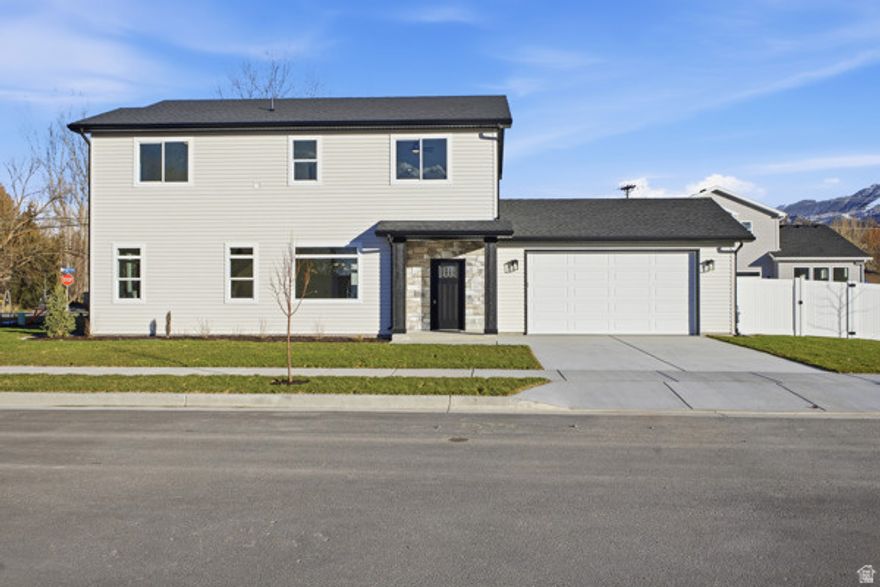 Come see this beautiful brand-new two-story home in Logan, Utah, currently under construction and scheduled to be completed within the next 60 days. Thoughtfully designed, this home offers a bright, open layout with large windows throughout, filling the space with natural light. The kitchen will feature quartz countertops, a large center island with sink, stylish cabinetry, and a side pantry for added storage. Upstairs, the owner's suite will include a ceiling fan for comfort and a spacious bathroom with a walk-in tiled shower, quartz countertop vanity, and a generous walk-in closet. Other planned finishes include durable flooring, modern fixtures, and well-planned storage solutions to make daily living both functional and stylish. The two-car garage will provide ample parking and workspace, while the exterior will be completed with fresh landscaping, a welcoming covered front porch, and a spacious driveway. This home is currently under construction and is expected to be fully finished within the next 60 days. Progress photos may vary slightly from the final details. Located in a new subdivision, this is a fantastic opportunity to own a brand-new home in Logan. Square footage figures are provided as a courtesy estimate only and were obtained from the plans. Buyer is advised to obtain an independent measurement.
