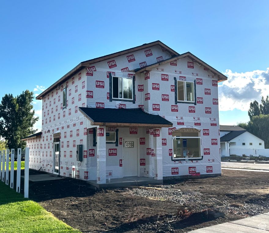 Come see this beautiful brand-new two-story home in Logan, Utah, currently under construction and scheduled to be completed within the next 60 days. Thoughtfully designed, this home offers a bright, open layout with large windows throughout, filling the space with natural light. The kitchen will feature quartz countertops, a large center island with sink, stylish cabinetry, and a side pantry for added storage. Upstairs, the owner's suite will include a ceiling fan for comfort and a spacious bathroom with a walk-in tiled shower, quartz countertop vanity, and a generous walk-in closet. Other planned finishes include durable flooring, modern fixtures, and well-planned storage solutions to make daily living both functional and stylish. The two-car garage will provide ample parking and workspace, while the exterior will be completed with fresh landscaping, a welcoming covered front porch, and a spacious driveway. This home is currently under construction and is expected to be fully finished within the next 60 days. Progress photos may vary slightly from the final details. Located in a new subdivision, this is a fantastic opportunity to own a brand-new home in Logan. Square footage figures are provided as a courtesy estimate only and were obtained from the plans. Buyer is advised to obtain an independent measurement.
