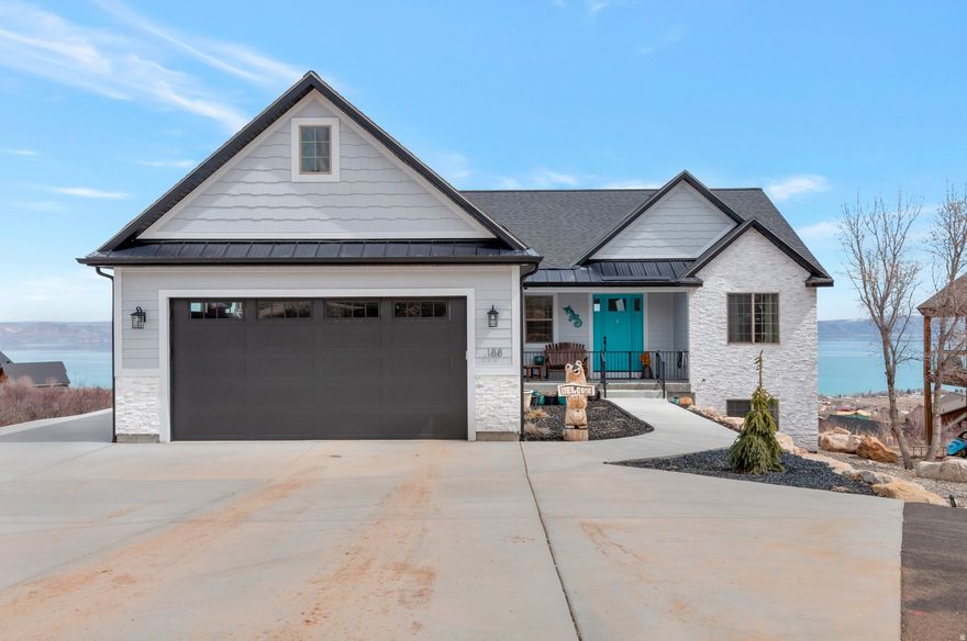 Upgraded beautiful home with stunning views of Bear Lake and surrounding mountains. Inviting landscaped front yard with a paved driveway . Upgraded appliances and custom cabinets in the kitchen with a fantastic dining area with panoramic views.  Primary bedroom located on the main floor with a luxurious bathroom and spacious closet. This home has a dual/ zone heating system and climate controlled garage. Basement equipped with a kitchenette and second laundry room. Property has on site RV hook up and its EV ready.  Come see this fabulous home!!